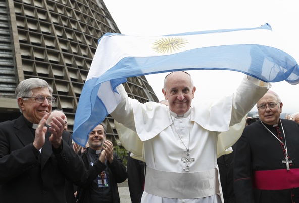 Pope Francis holds up Argentina's flag outside cathedral during World Youth Day visit to Brazil
